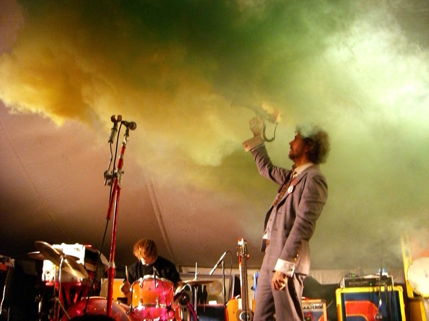 Concert with bright lights, fog, and man with megahorn
